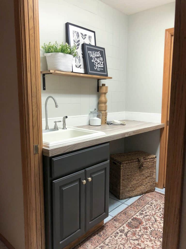 Painted oak cabinet in a laundry room.