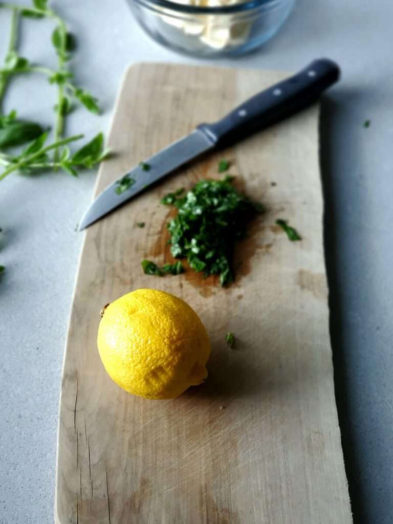 Lemon with basil being chopped.