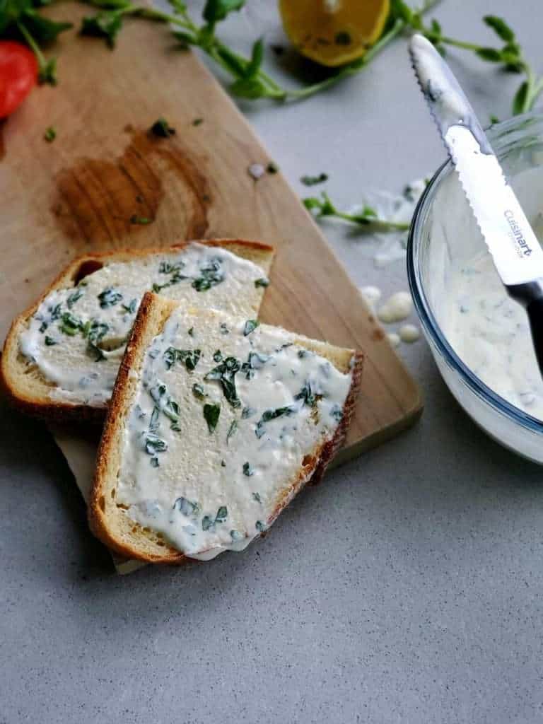 Lemon basil mayo spread on bread.