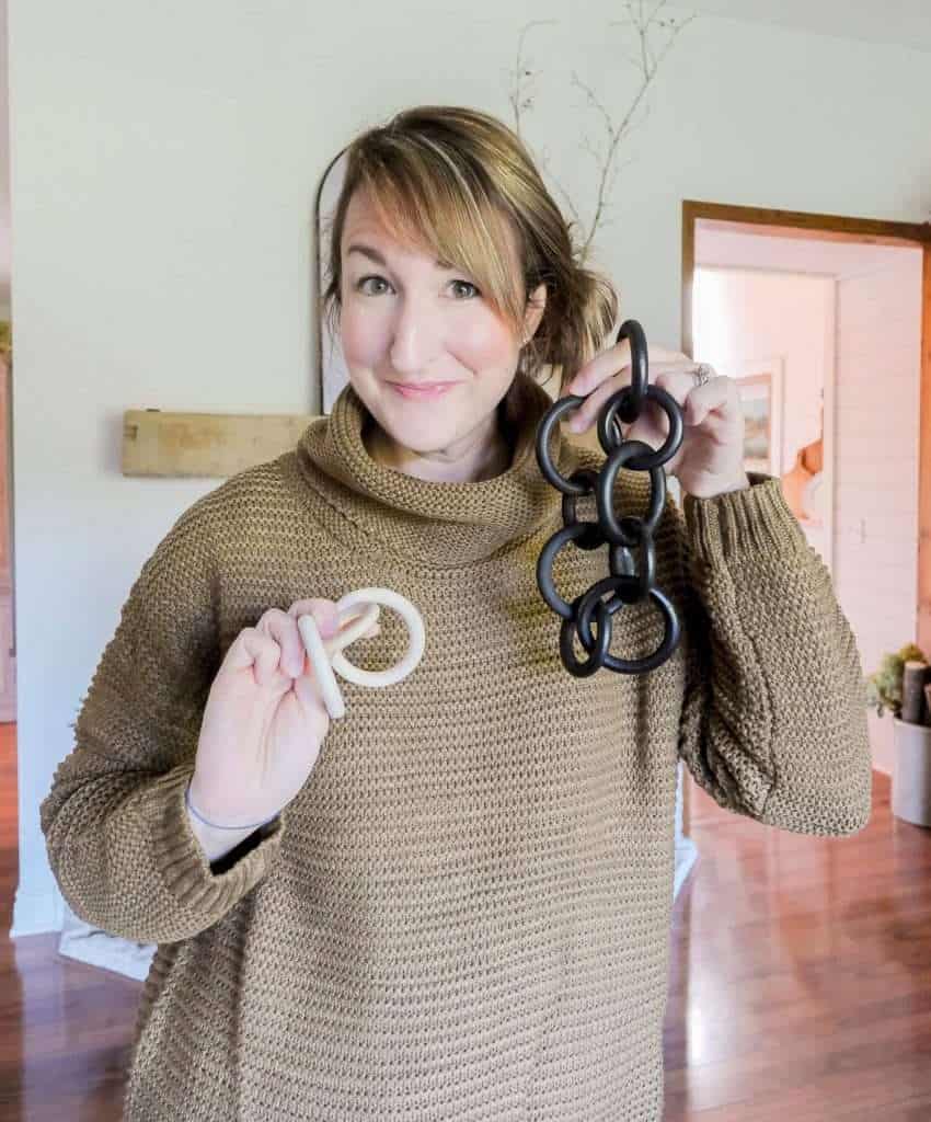 Woman holding DIY wood links.