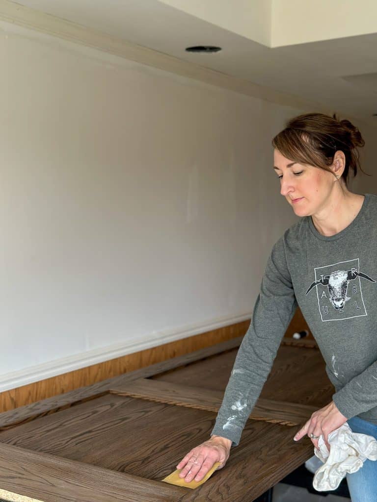 Sanding a stained door.