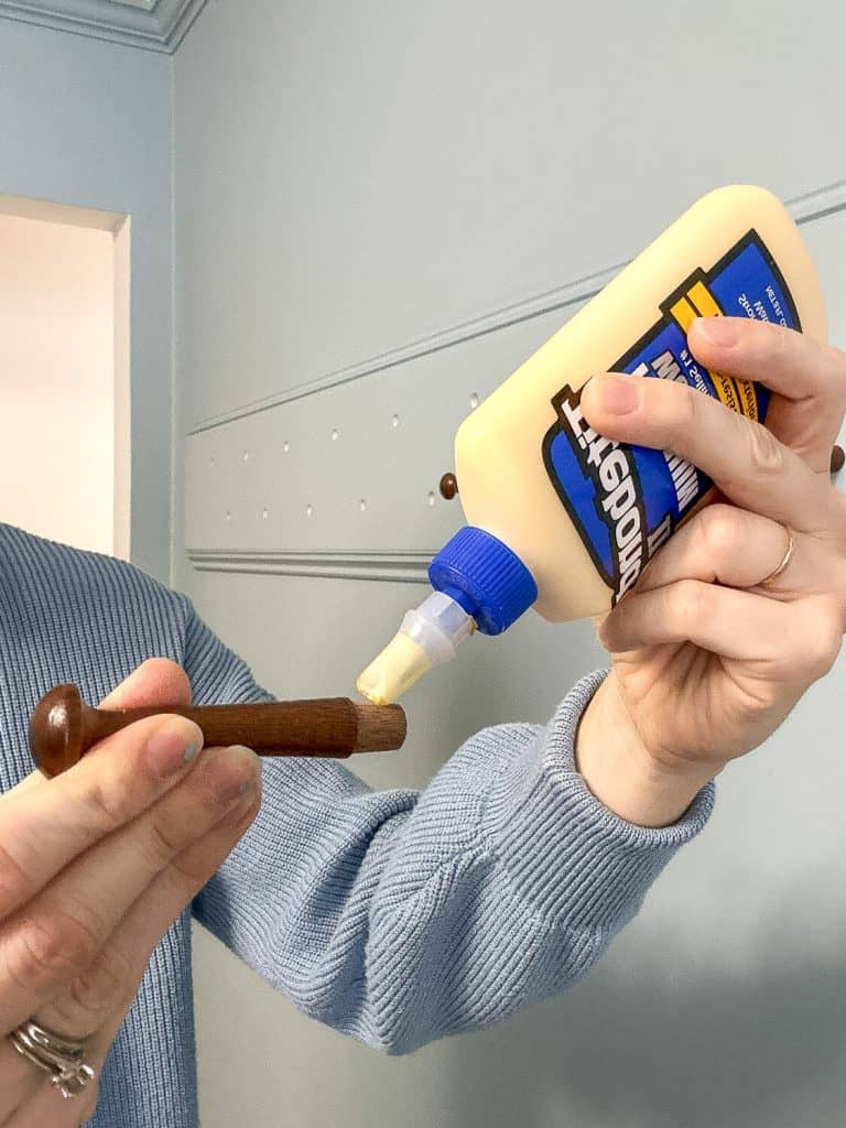 Applying wood glue to peg.