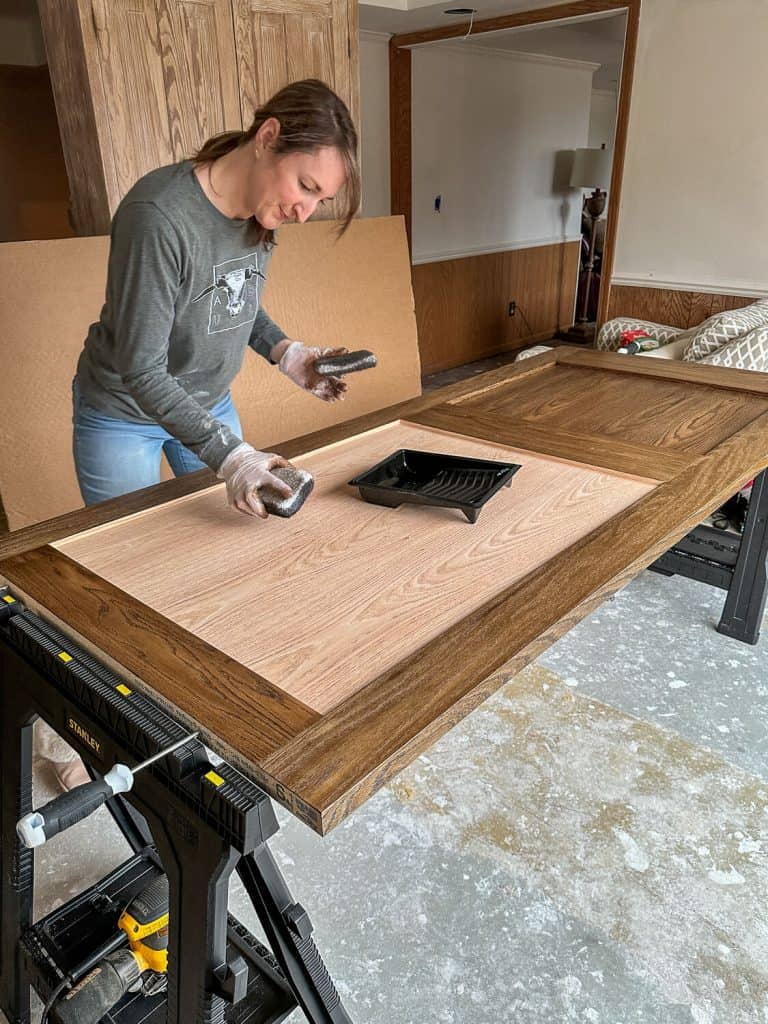 Applying stain to an oak door.