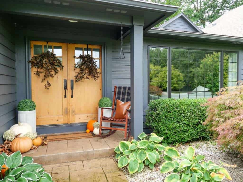 Front porch decorated for fall.