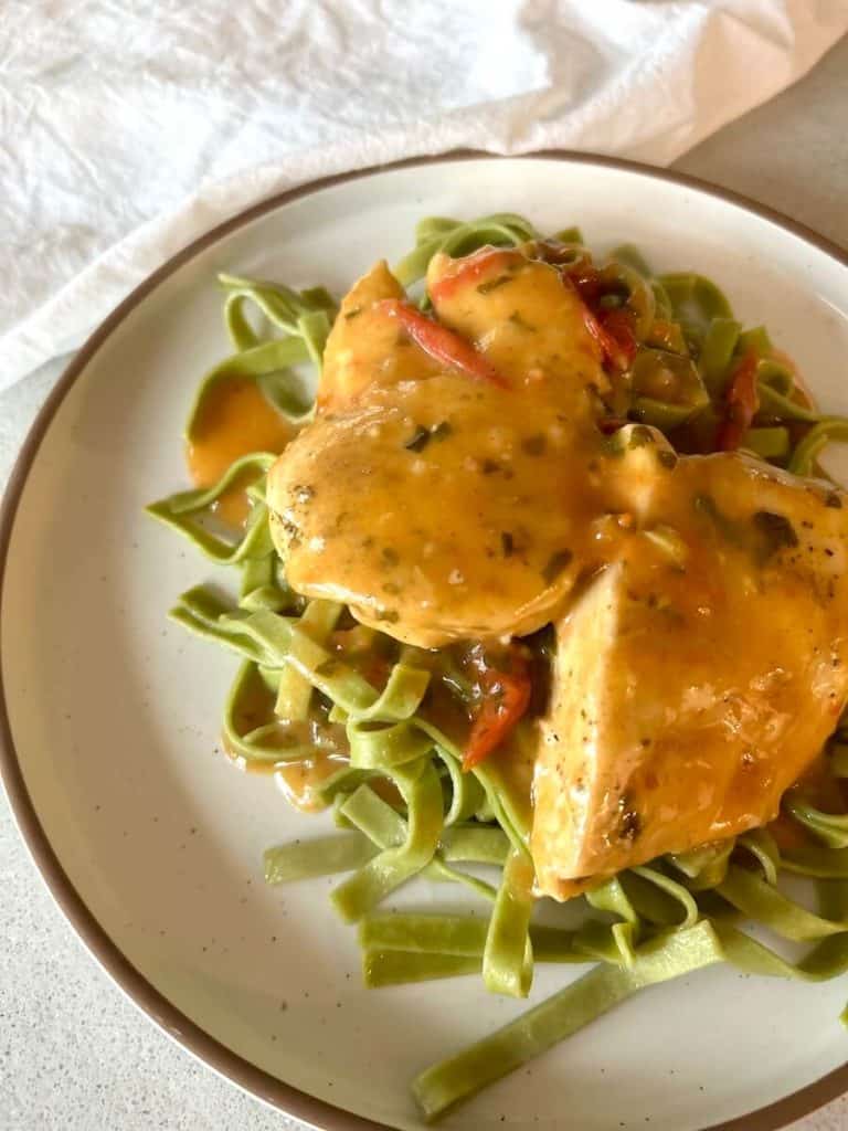 Chicken and pasta on a plate.