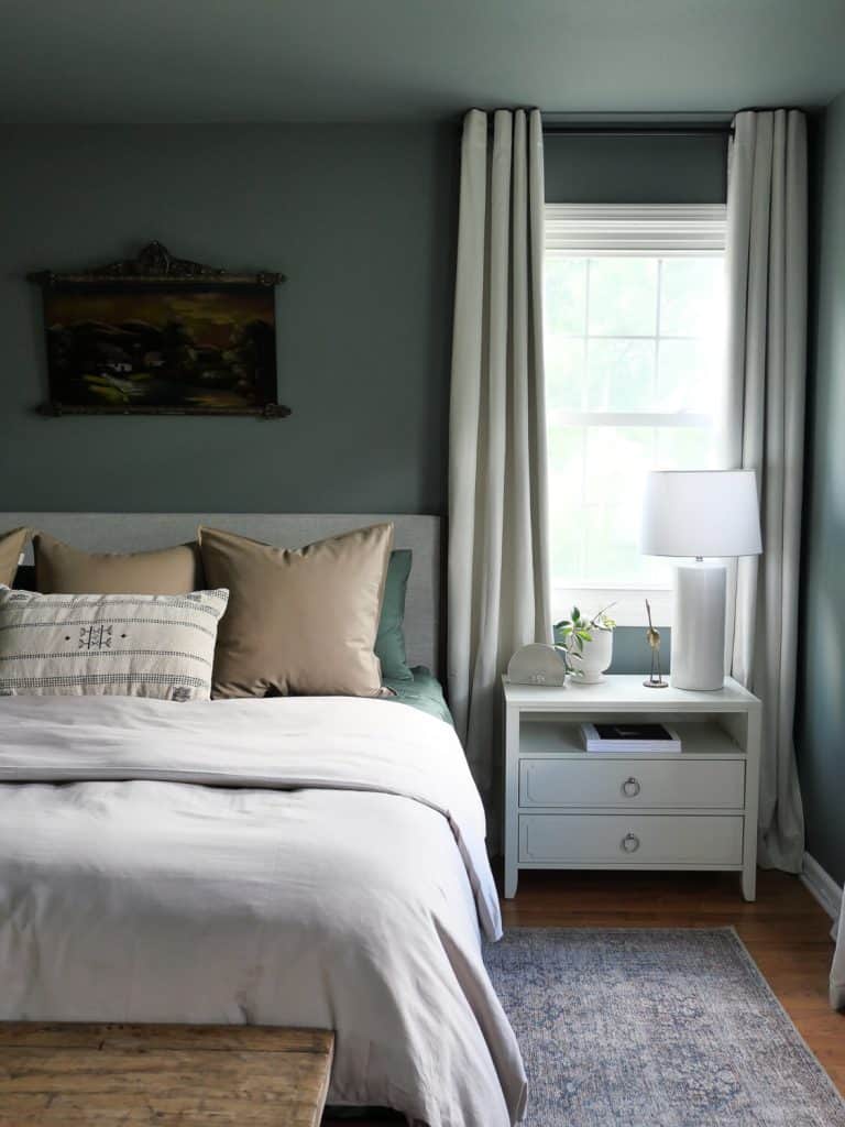 Organic modern color palette in a bedroom with green walls.