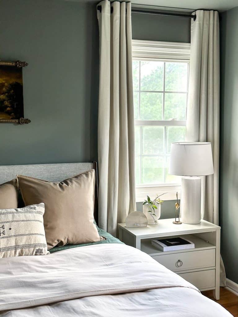 Bedroom looking at a nightstand under a window.