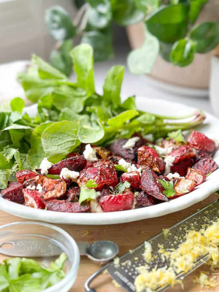 Roasted radishes and beets on a plate.