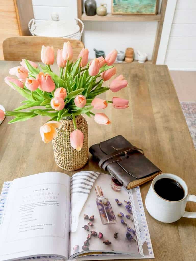 Book and coffee mug with flowers.