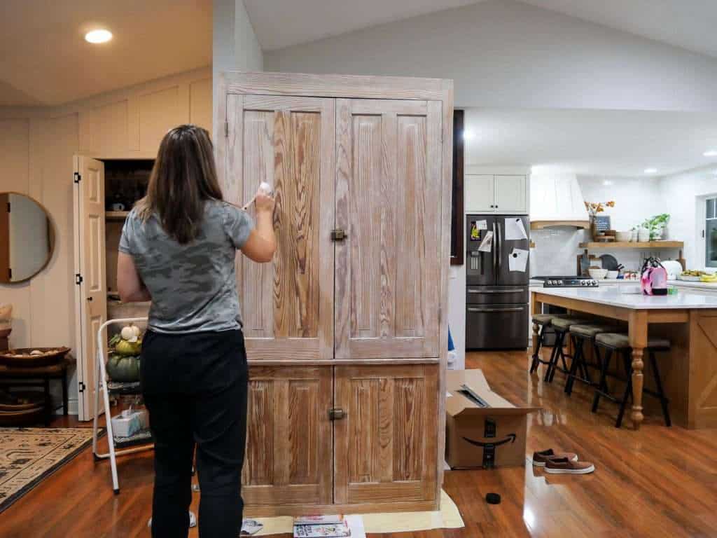 Applying liming wax for how to lighten stained wood.