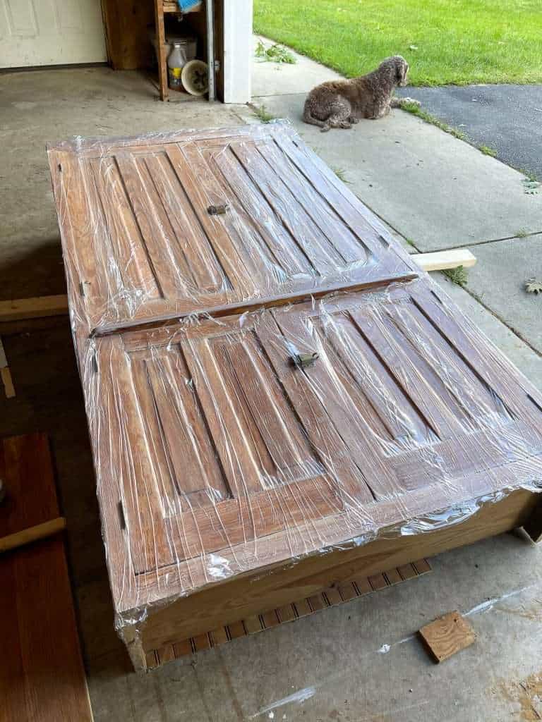 Saran wrap covered cabinet being stripped.