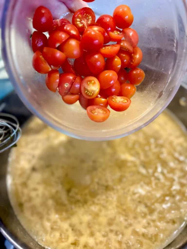 Adding cherries to sauce.