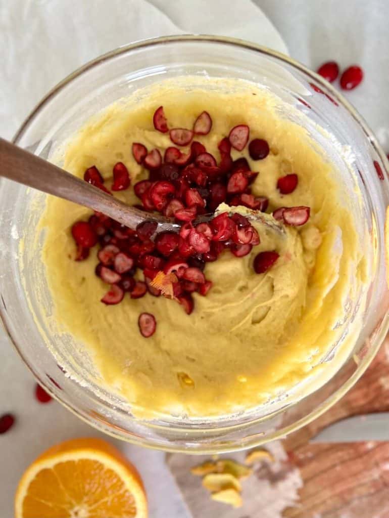 Adding cranberries to gluten free cranberry orange muffins.