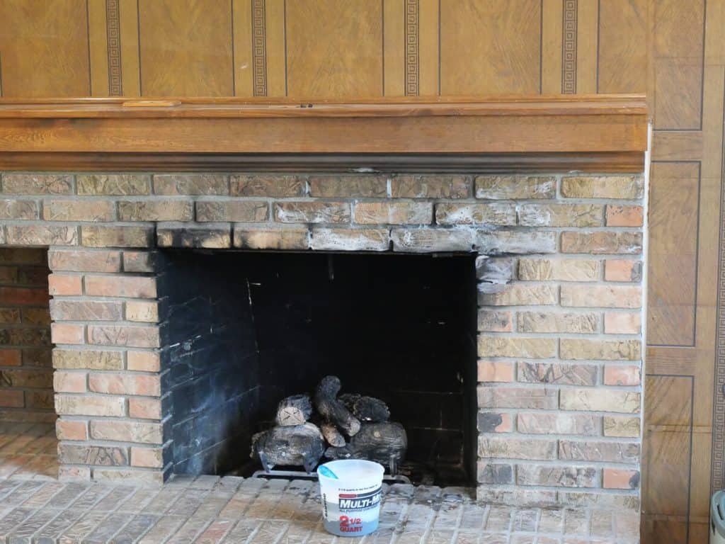 Cleaning fireplace brick.