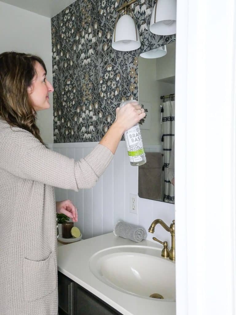 Woman washing a bathroom.