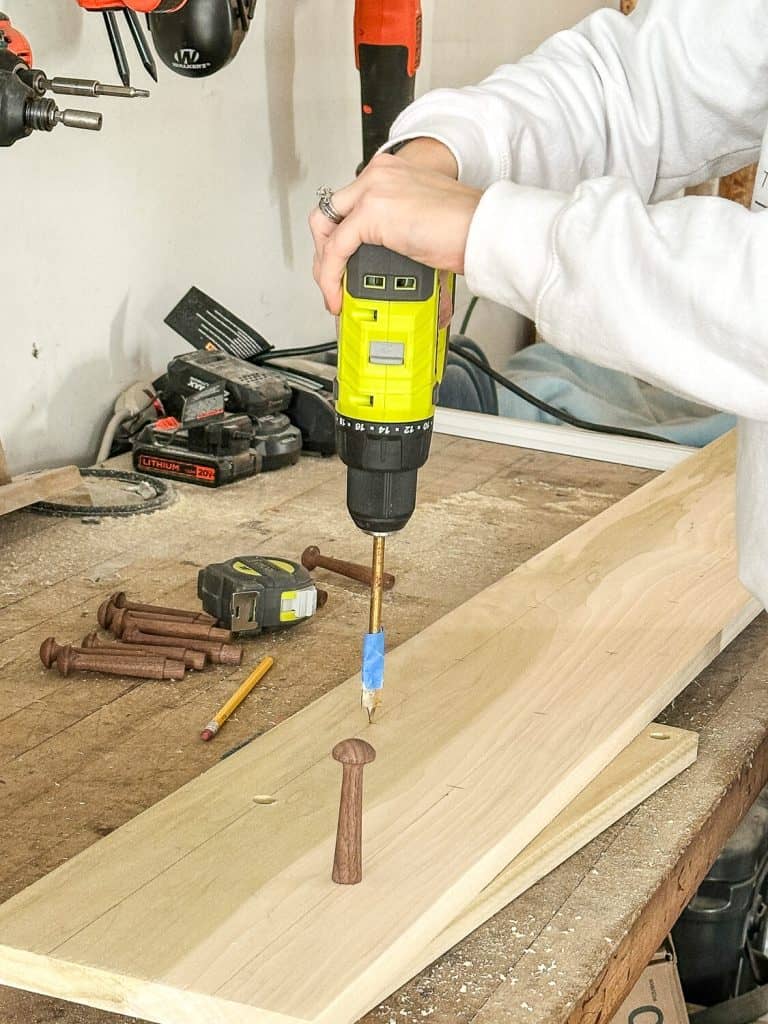 Drilling holes into a board.