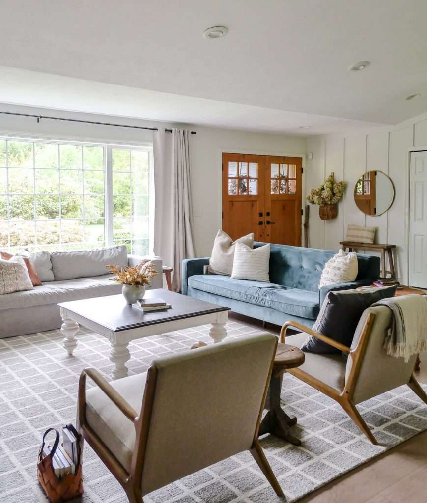 Living room with arm chairs and a velvet sofa.