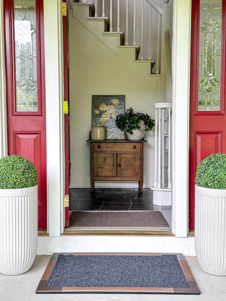 Boxwood spheres on a front porch.