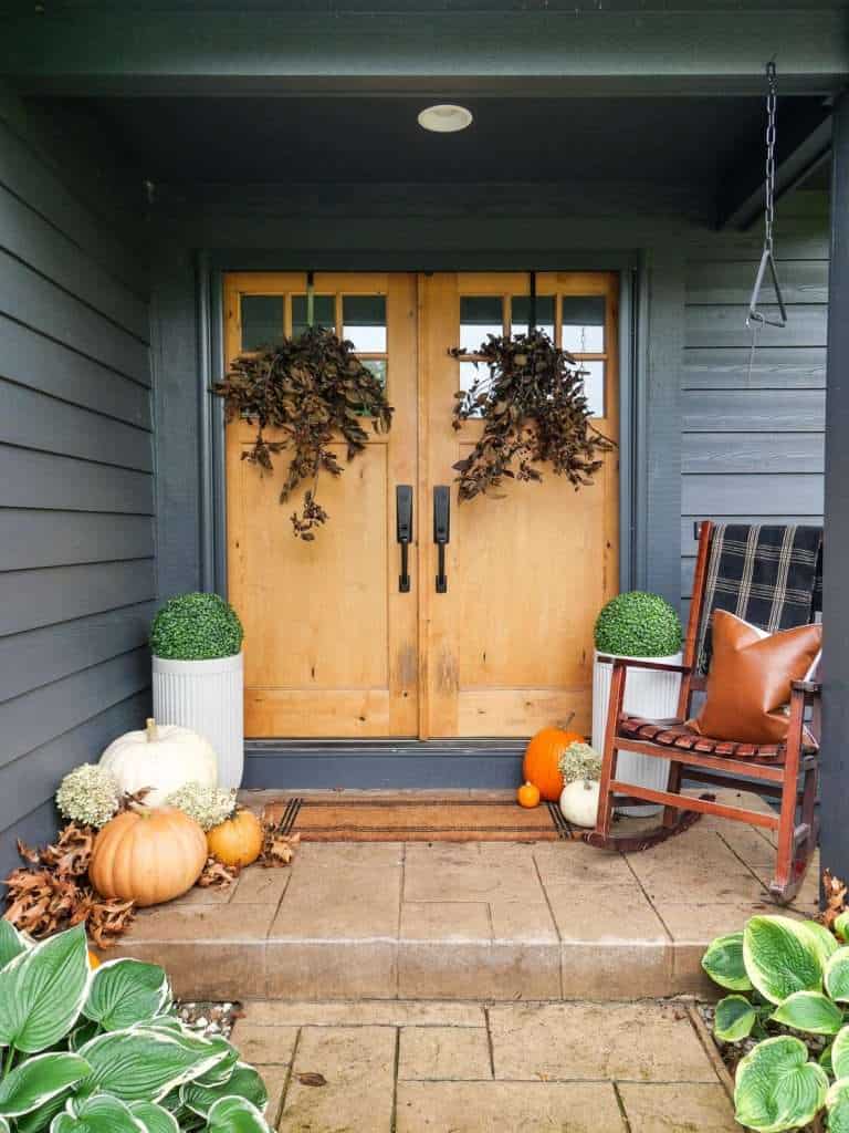 Balanced front door with two planters.