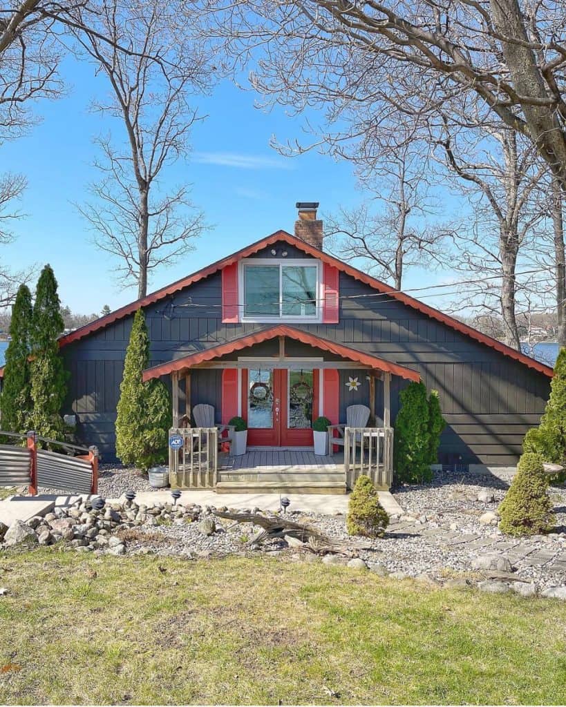 Faux topiaries on the front porch of a cottage.