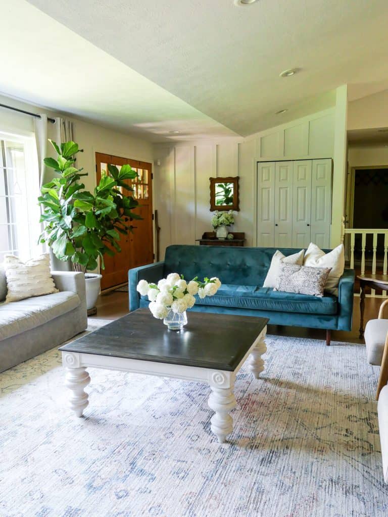 Living room with velvet sofa.