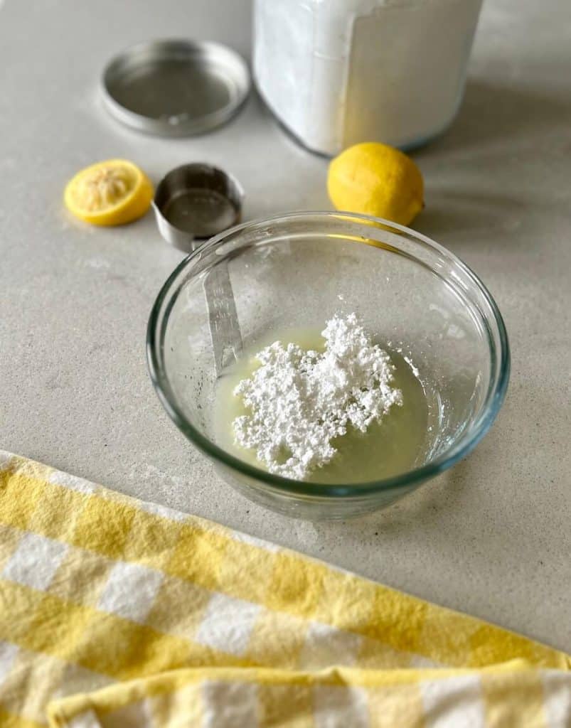 Adding powdered sugar to glaze.