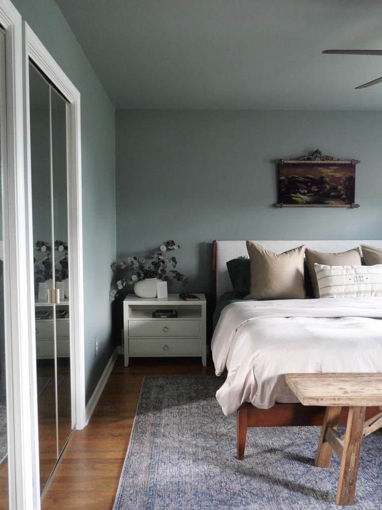 Green bedroom with painted ceiling.