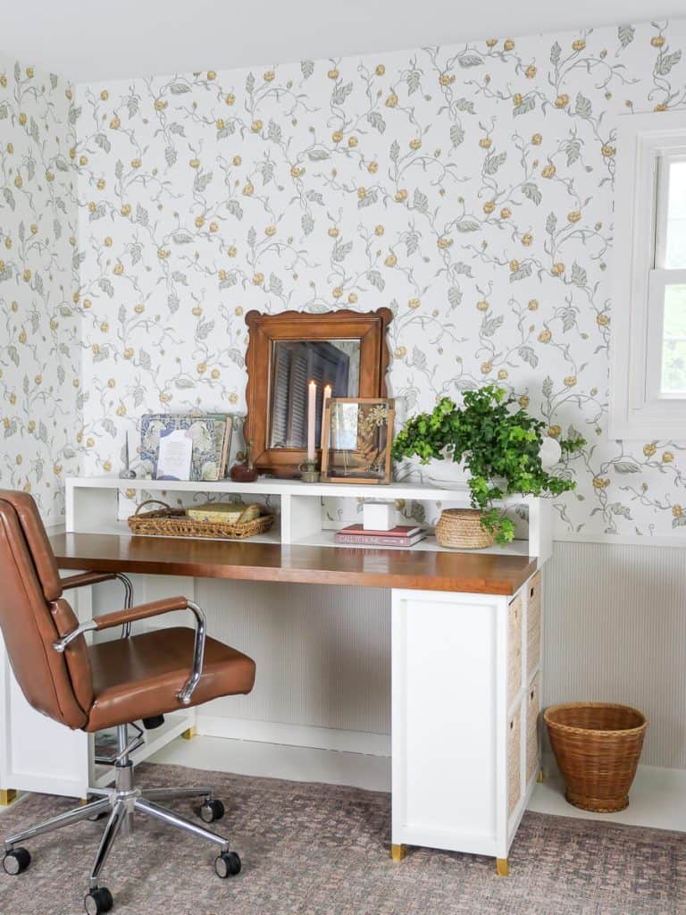 Office with floral wallpaper.