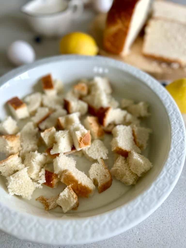 Tearing bread for french toast bake.