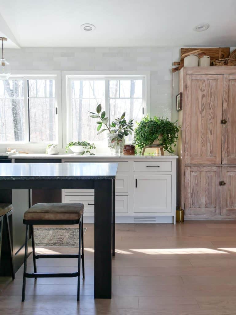 Minimalist Kitchen island with counter stool and wood cabinet.