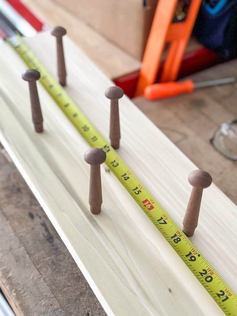 Tape measure laying out pegs for a peg rail.