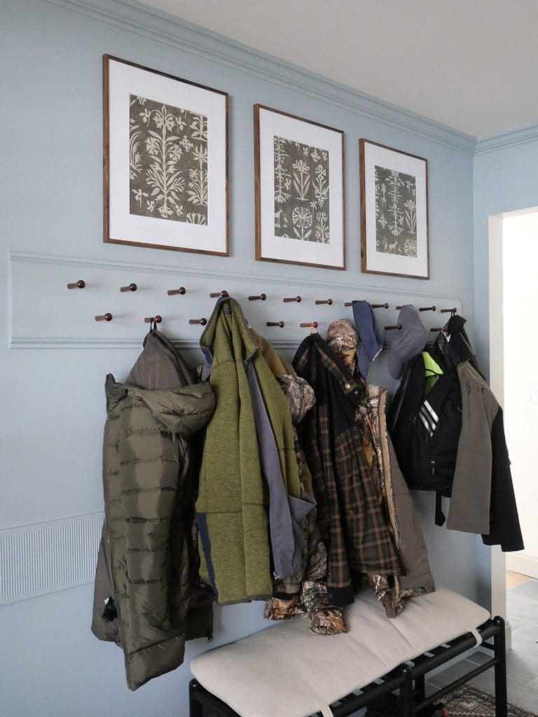 Coats on a peg rack.