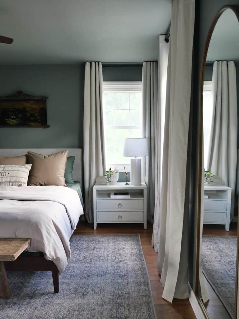 Moody green bedroom with painted ceiling.