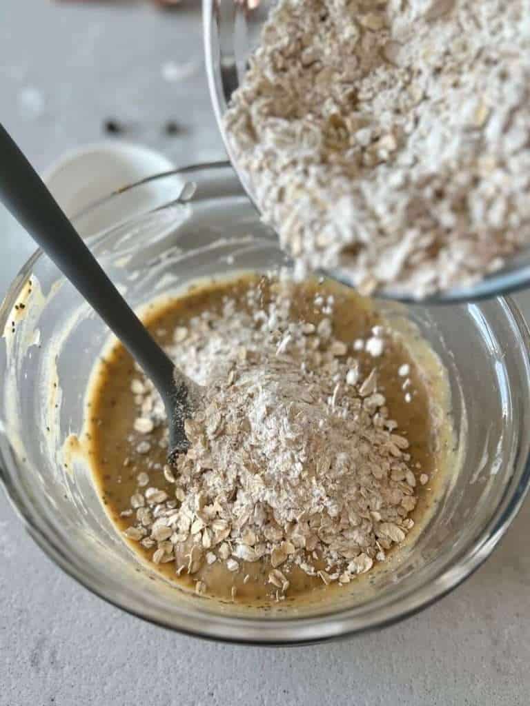 Adding flour to gluten free banana bars.