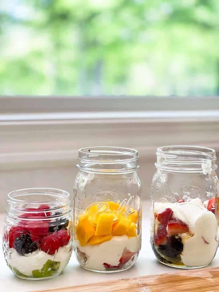 Layered yogurt and fruit in a mason jar.