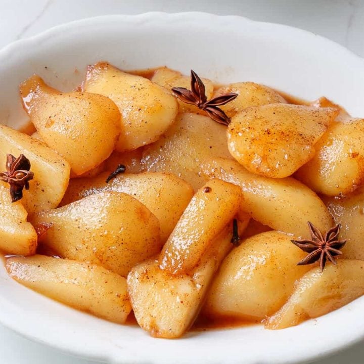 Sliced stewed pears on a plate.