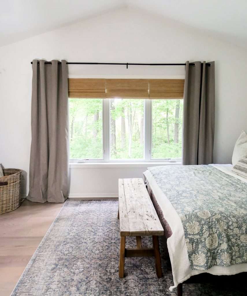 Window coverings in an organic modern bedroom.