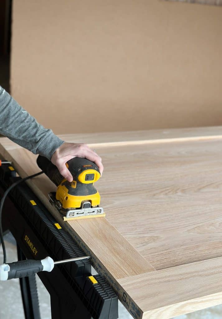 Sanding a door before staining.