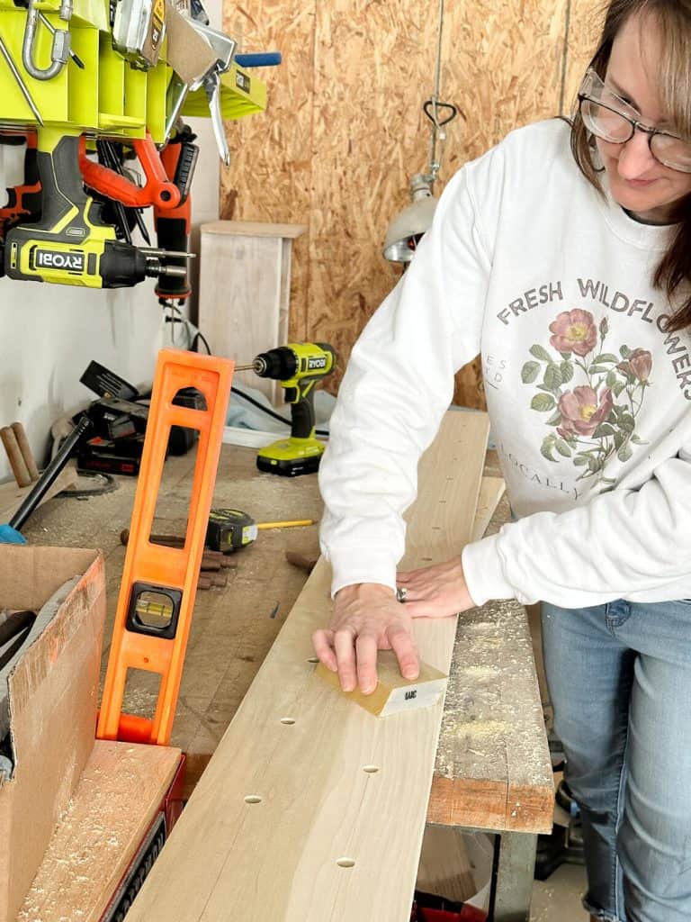 Woman sanding wood.