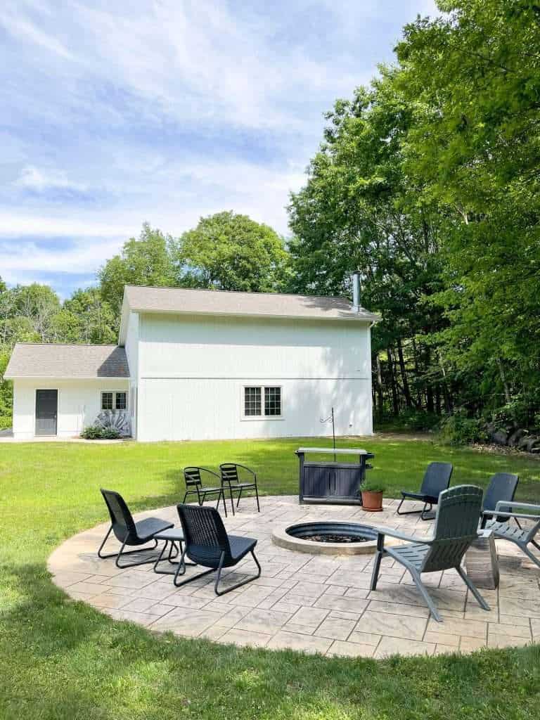 Fire pit with a white barn.