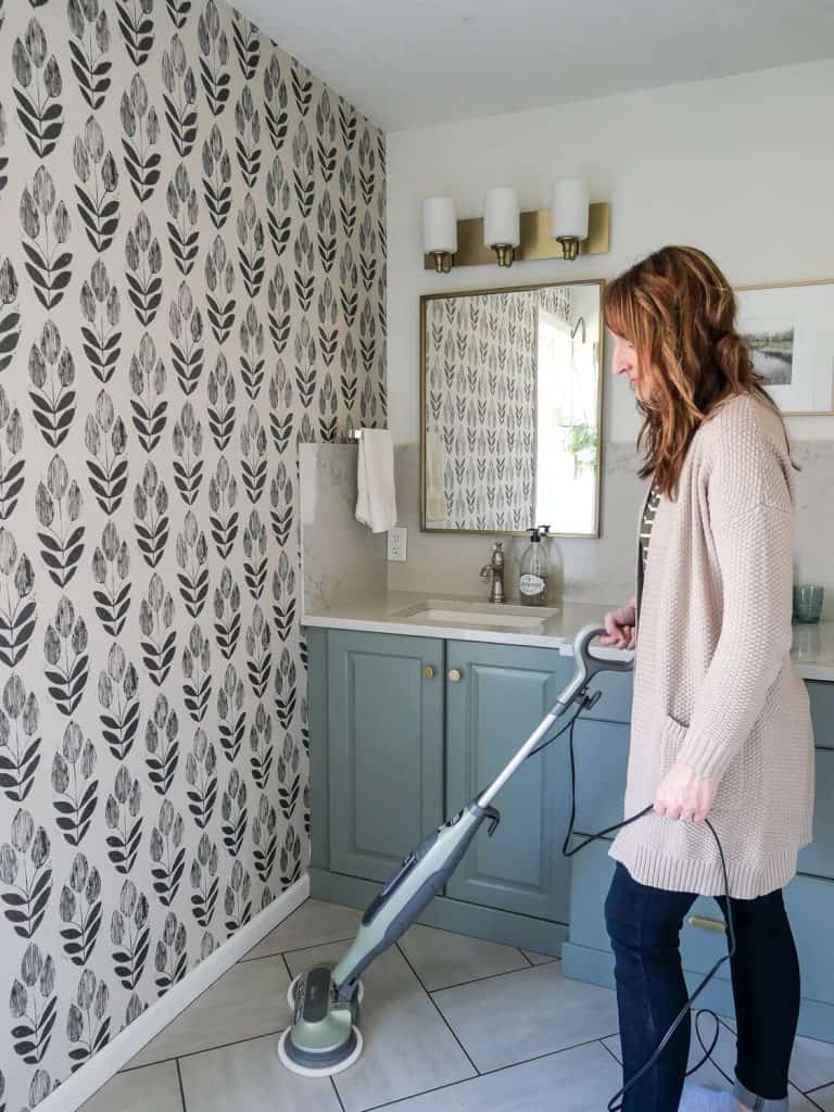 Woman using a steam mop for green spring cleaning.