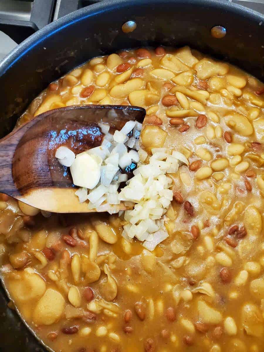 Add garlic to spicy cowboy beans