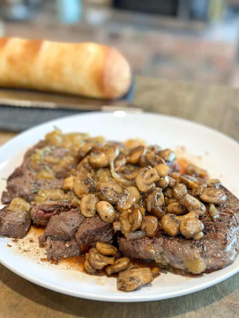 Mushrooms on top of venison.