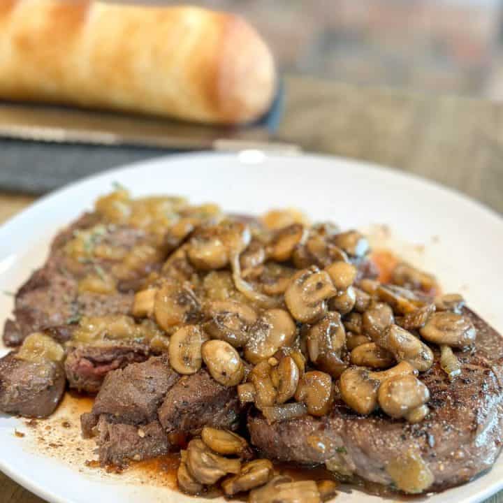 Mushrooms on top of venison.