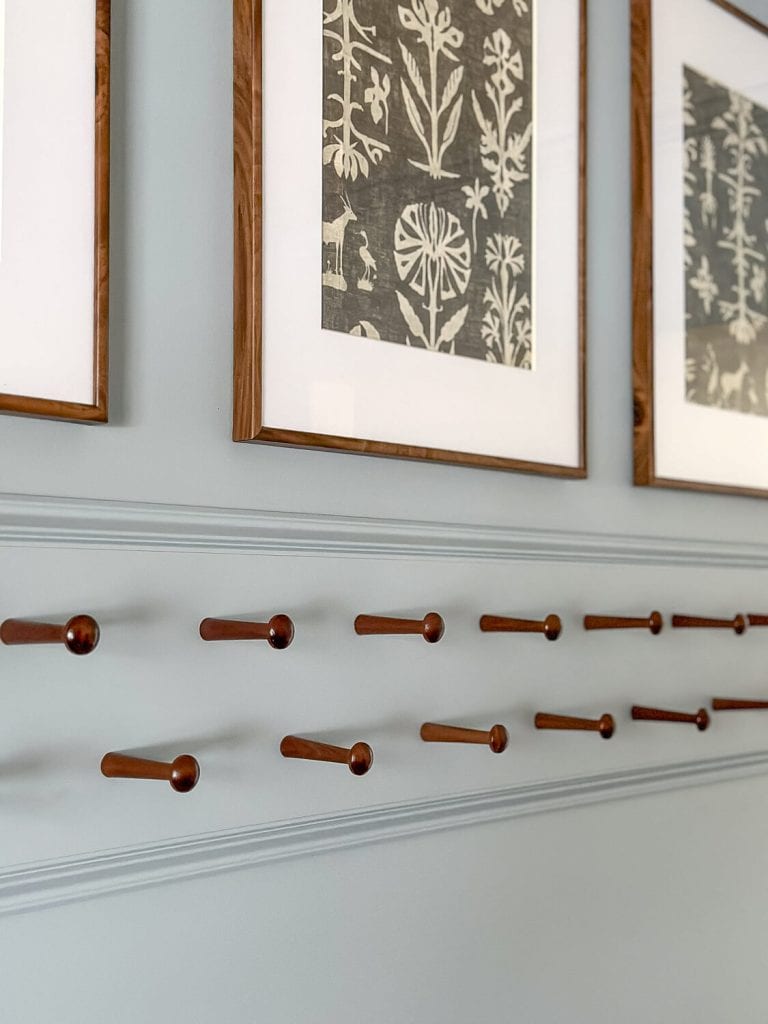 Walnut pegs on a peg rail.